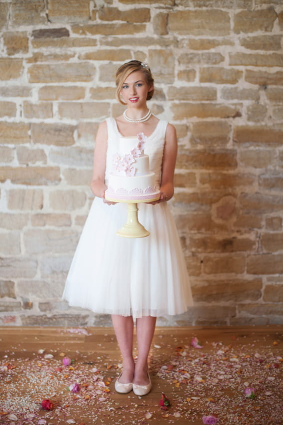 Bride holding wedding cake