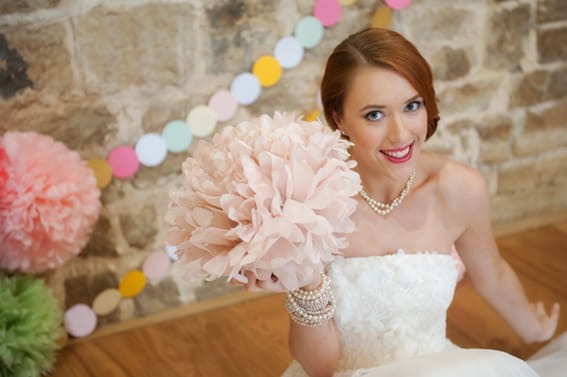 Bride holding paper pom pom