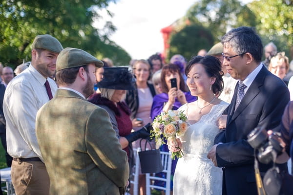 Father leading bride to groom