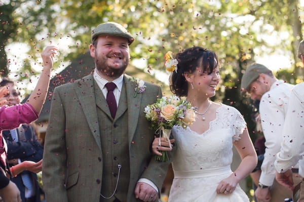 Bride and groom leave wedding ceremony