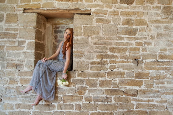 Bride sitting on wall