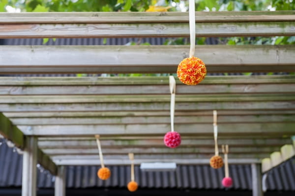 Pom poms hanging from beams