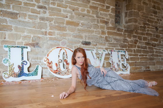 Bride laying in front of LOVE letters