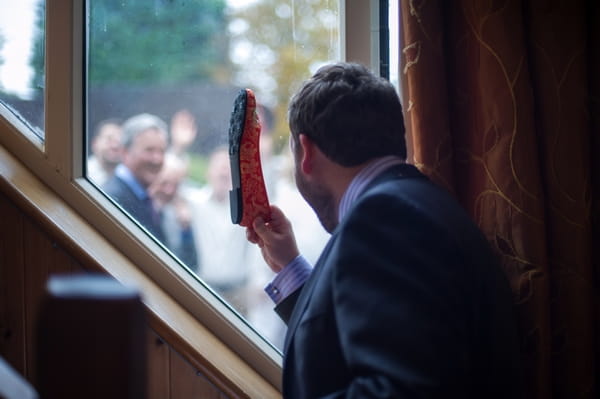 Groom holding bride's shoe