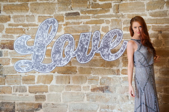 Bride standing next to LOVE letters