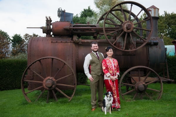 Bride and groom in front of old farm steam engine