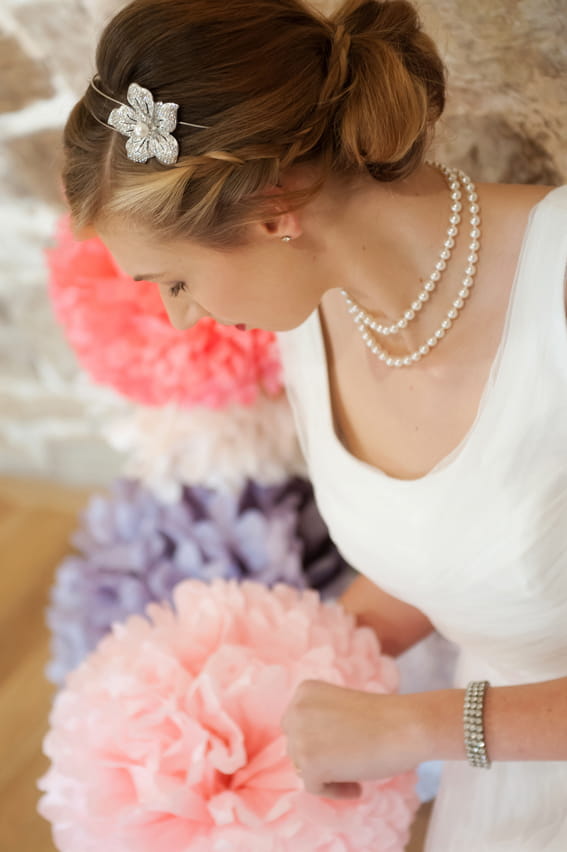 Bride looking at paper pom pom