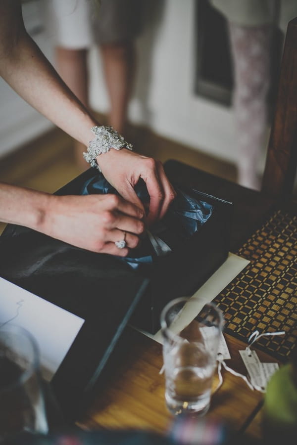 Bride taking necklace out of box