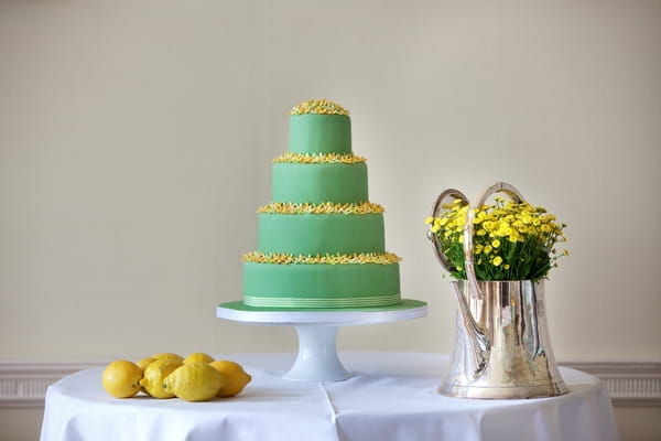 Green wedding cake with yellow flower detail
