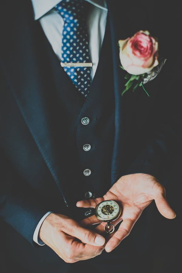 Groom looking at pocket watch