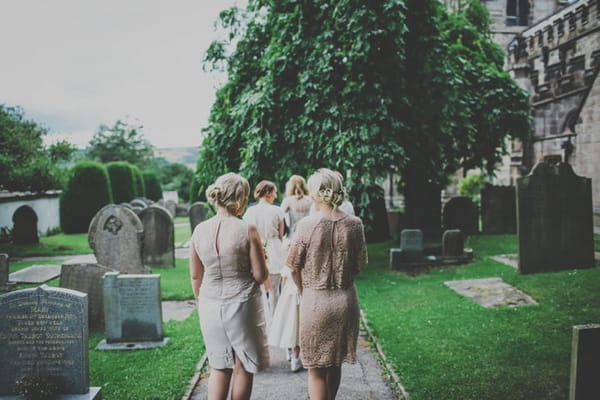 Bridesmaids walking down church path