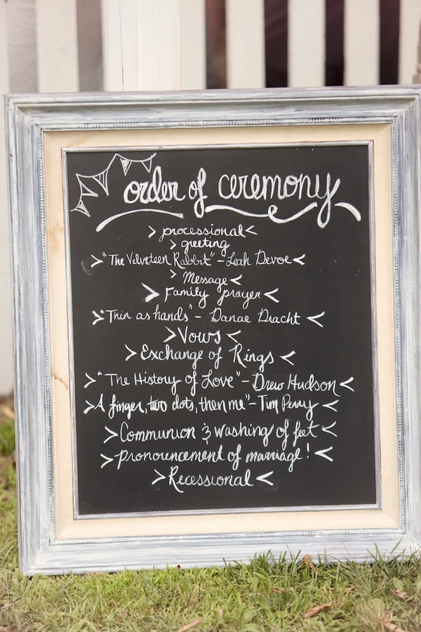 Wedding order of service written on chalkboard