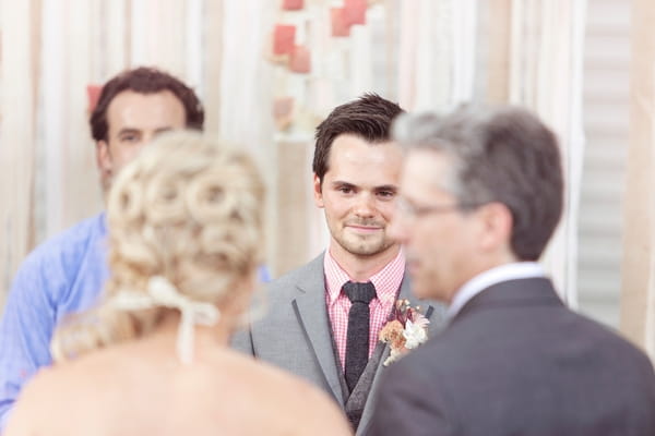 Groom seeing bride approach altar