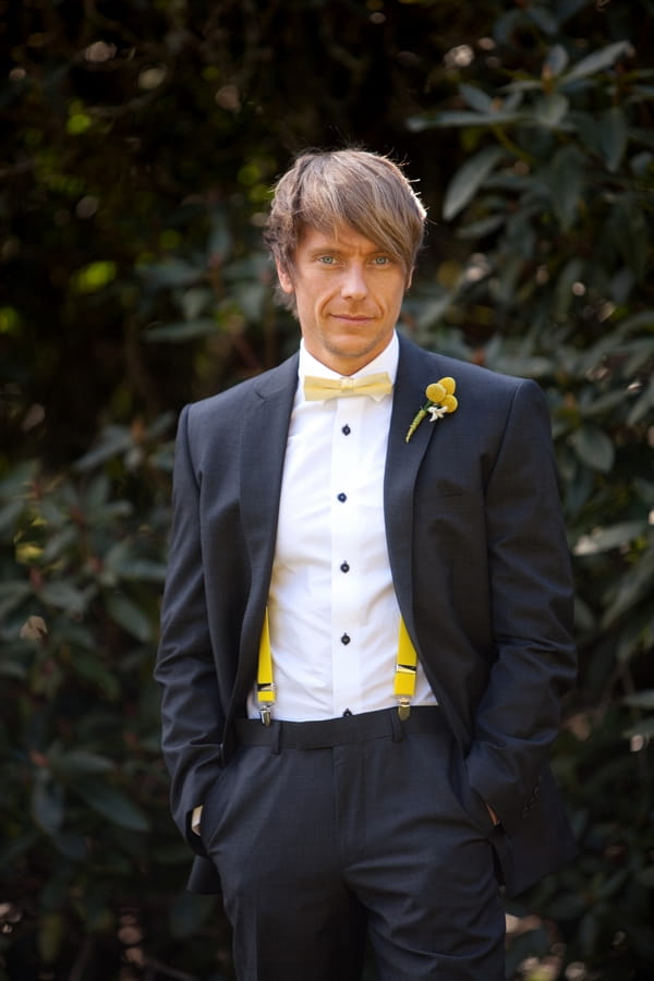 Groom with yellow bow tie and braces