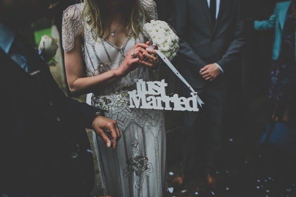 Bride holding just married sign