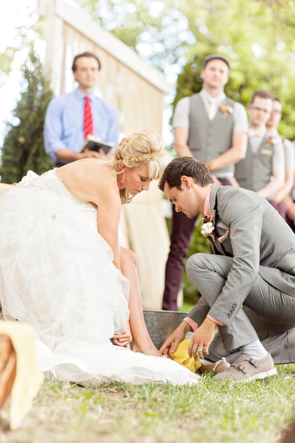 Groom washing bride's feet