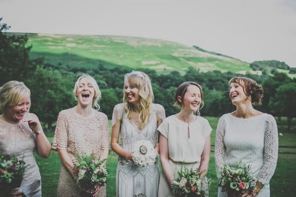 Bride and bridesmaids laughing