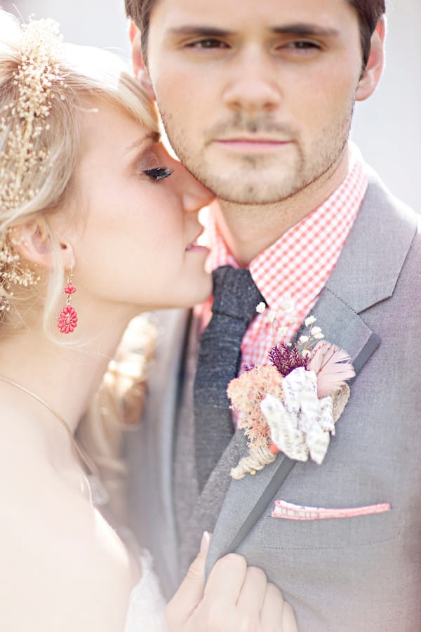 Bride kissing groom's neck