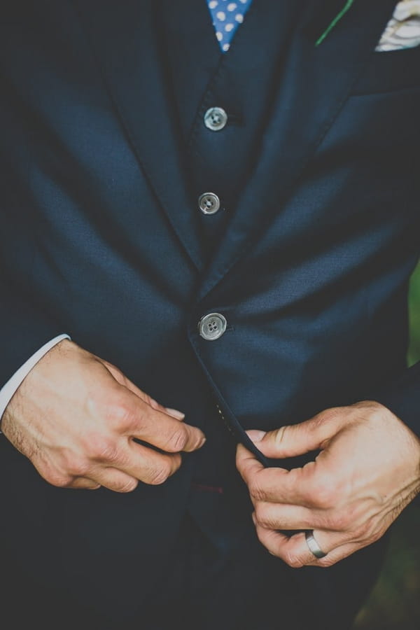 Groom adjusting waistcoat