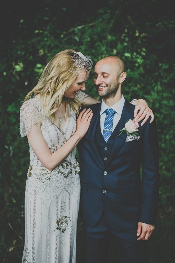 Bride with arms around groom's shoulders