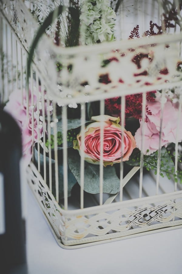 Birdcage with flowers in