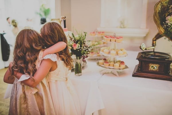 Flower girls at cake table