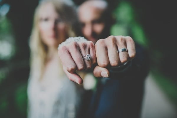 Bride and groom showing wedding rings