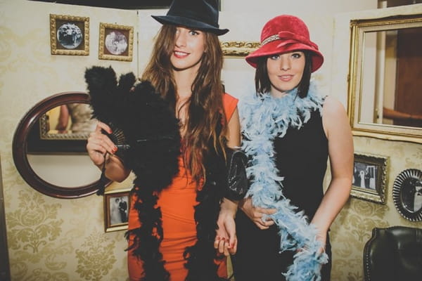 Wedding guests wearing photo booth props