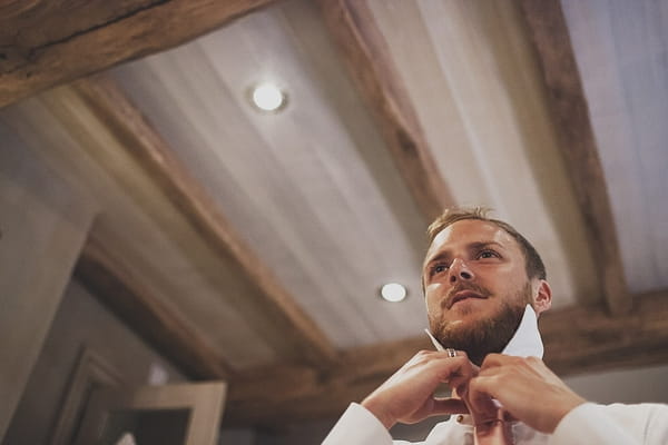 Groom doing up tie