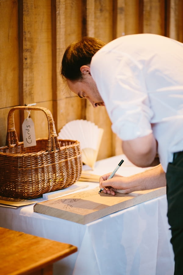 Wedding guest signing wood wedding guest book