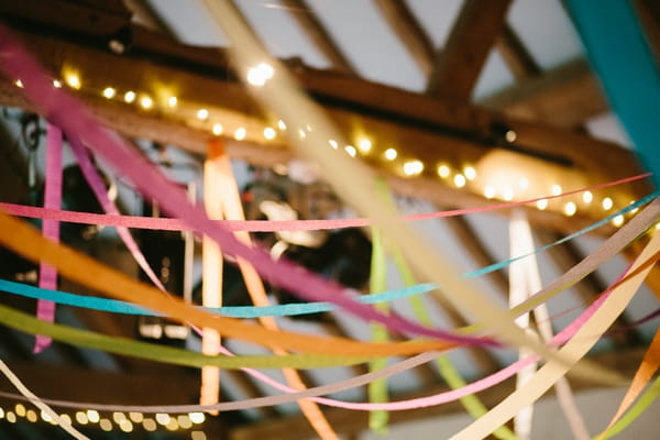 Coloured streamers across beamed ceiling