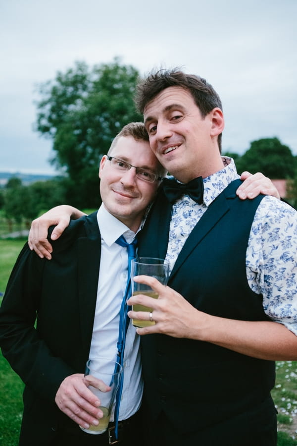 Groom with arm around best man