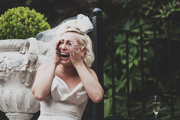 Bride with hands on face