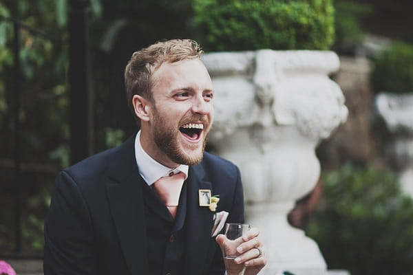 Groom laughing at speech