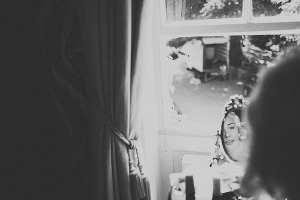 Reflection of bride's face in mirror