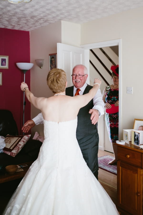 Bride and father about to hug