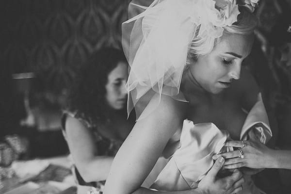 Bride putting Vivienne Westwood wedding dress on