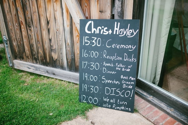 Wedding order of service written on chalkboard