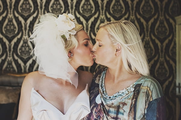 Bride kissing friend