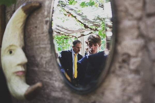 Reflection of guests entering wedding ceremony