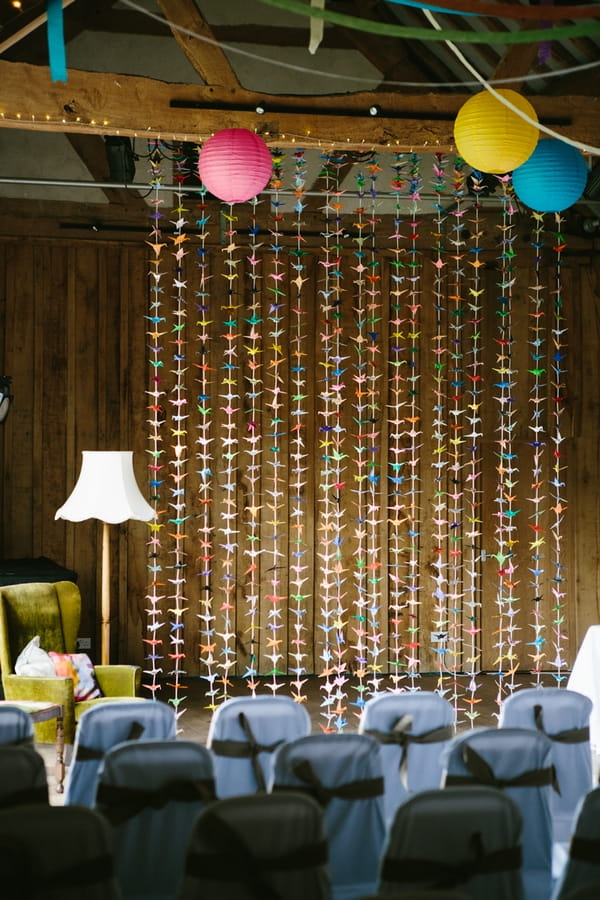 Origami paper cranes hanging in wedding ceremony