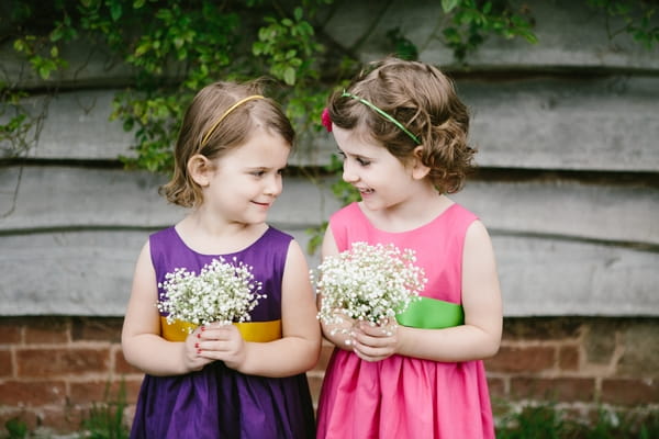 Flower girls in pink and purple dresses