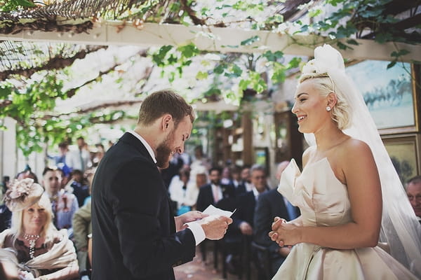 Groom reading in wedding ceremony