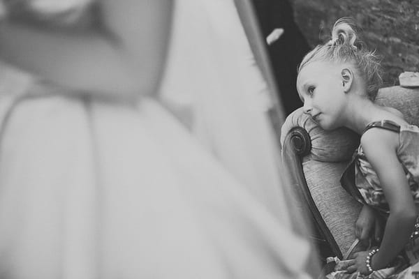 Young girl laying on chair in wedding ceremony