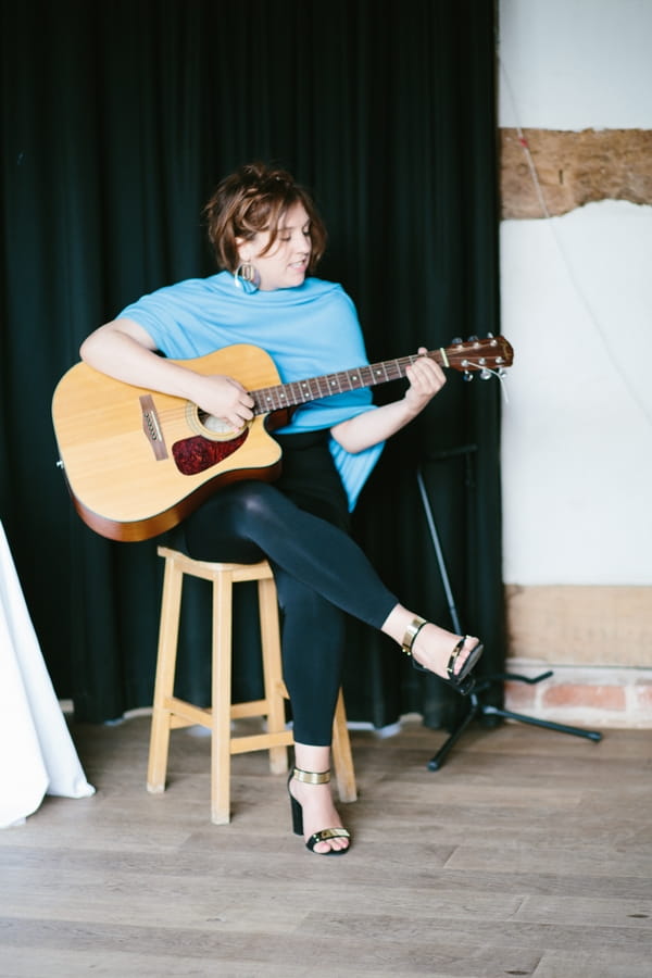 Woman playing guitar at wedding