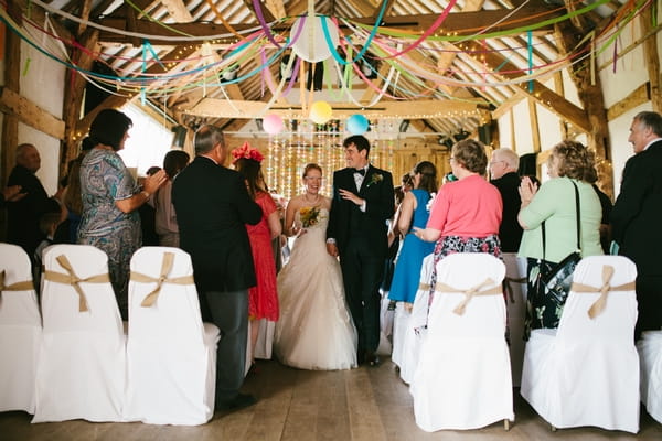 Bride and groom leaving wedding ceremony