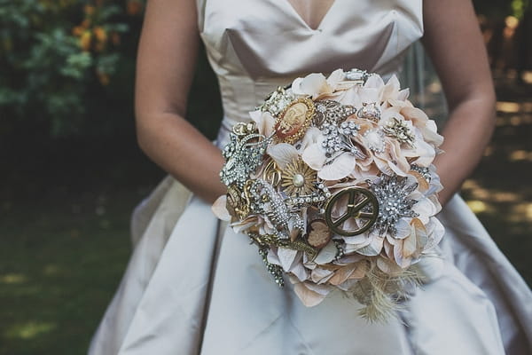 Bride holding brooch bouquet