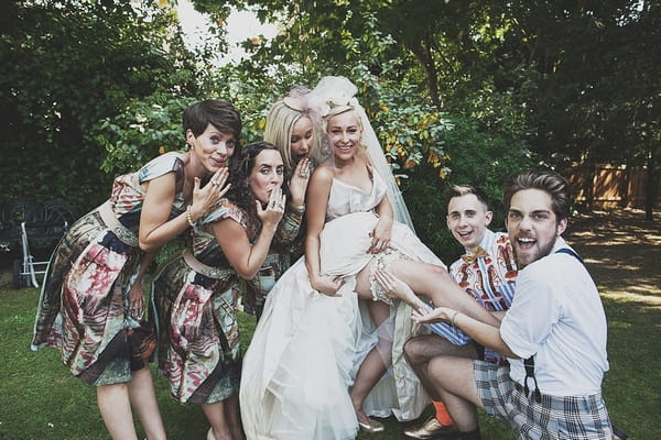 Bride showing garter to wedding party