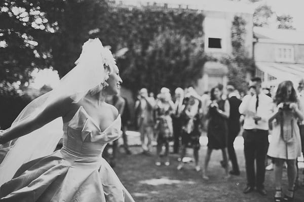 Wedding guests looking at bride