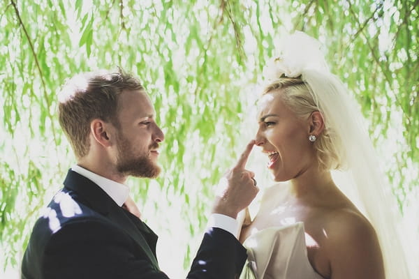 Groom touching bride's nose